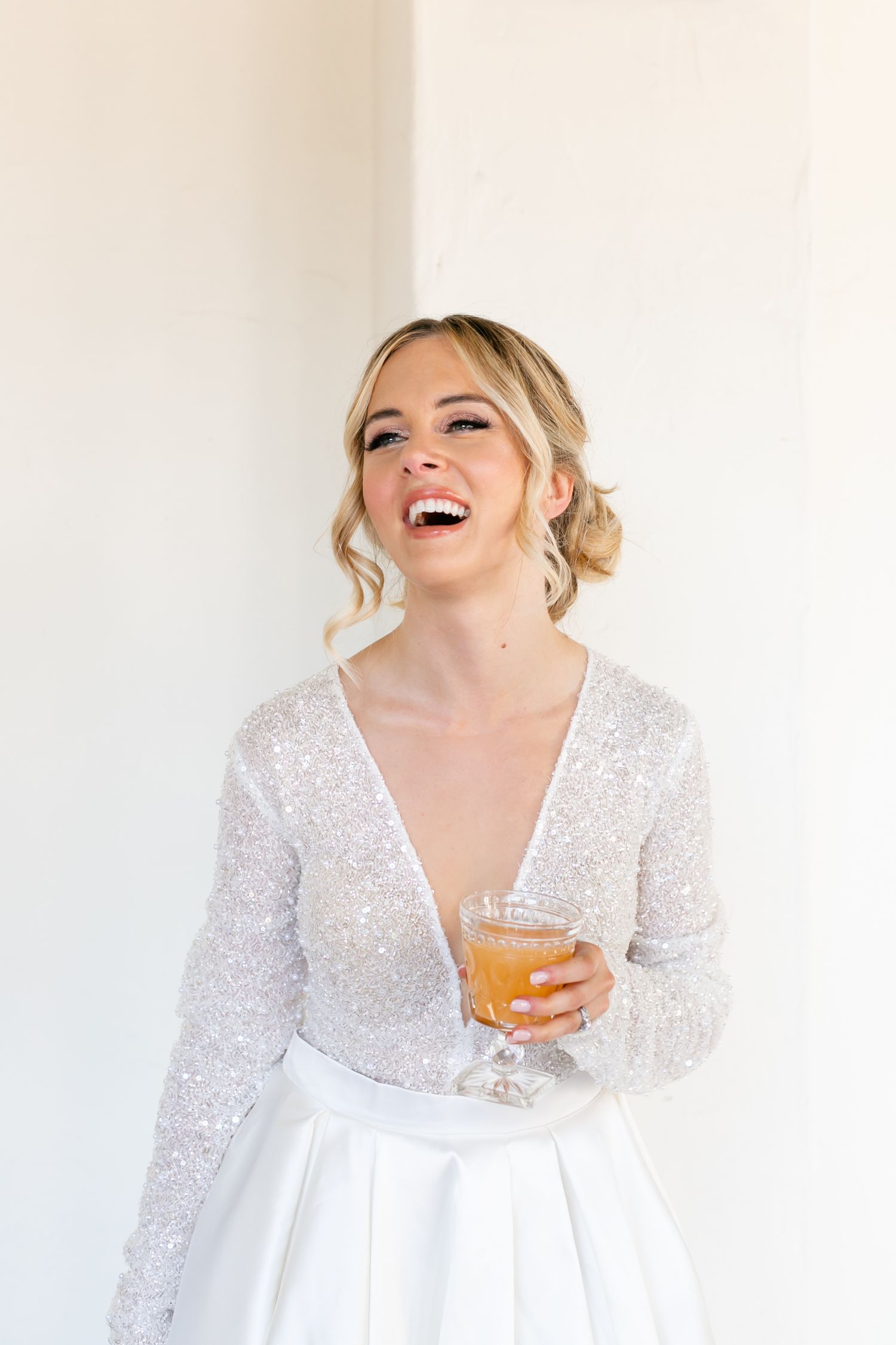 bride laughs as she drinks