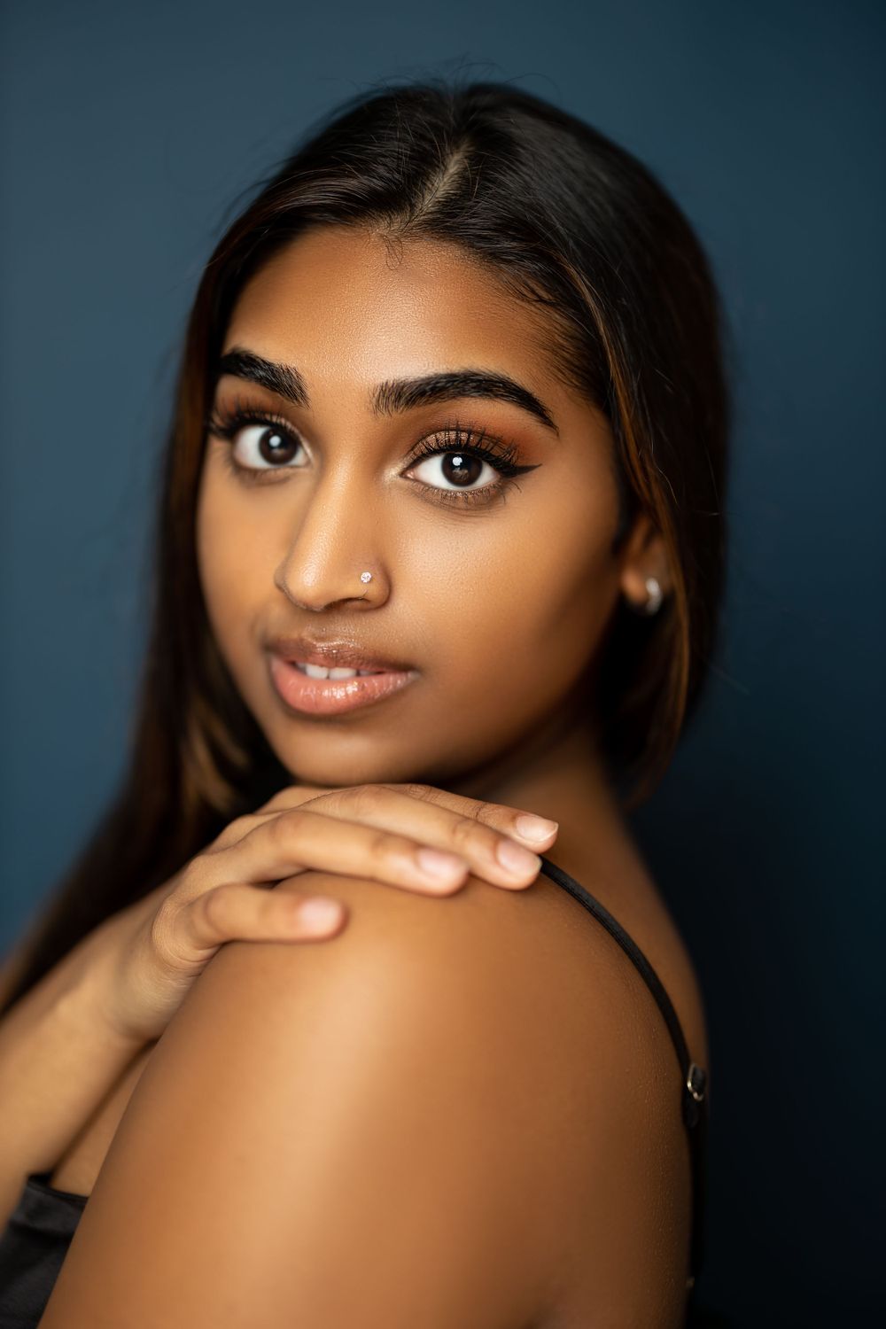 Close-up beauty portrait highlighting glowing skin and flawless makeup.