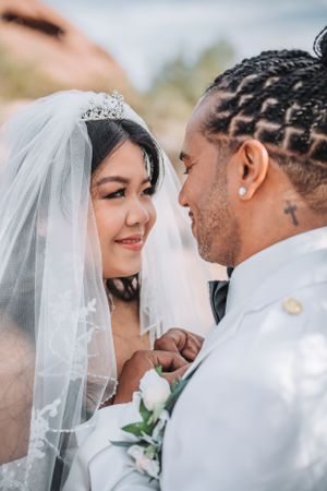 An intimate close-up of a wedding couple sharing a tender moment.