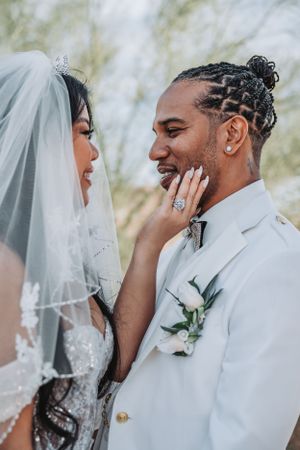 Genuine moment of joy captured between newlyweds in elegant white wedding attire.