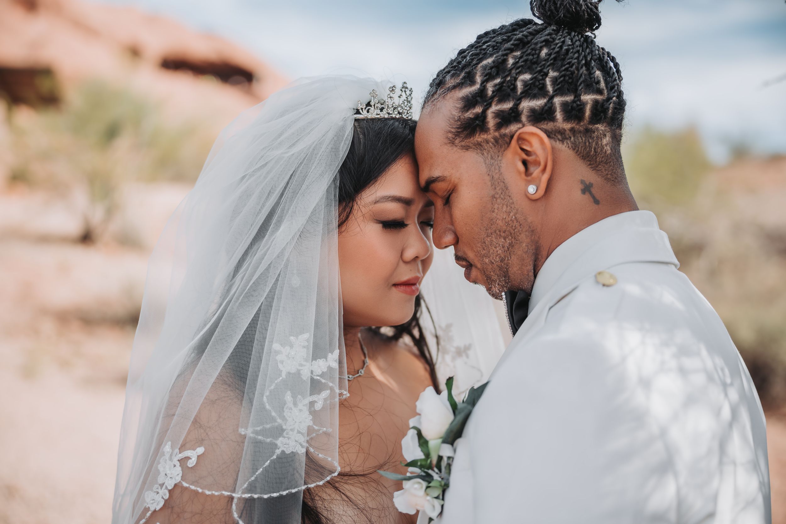 An intimate close-up portrait of newlyweds sharing a tender moment.
