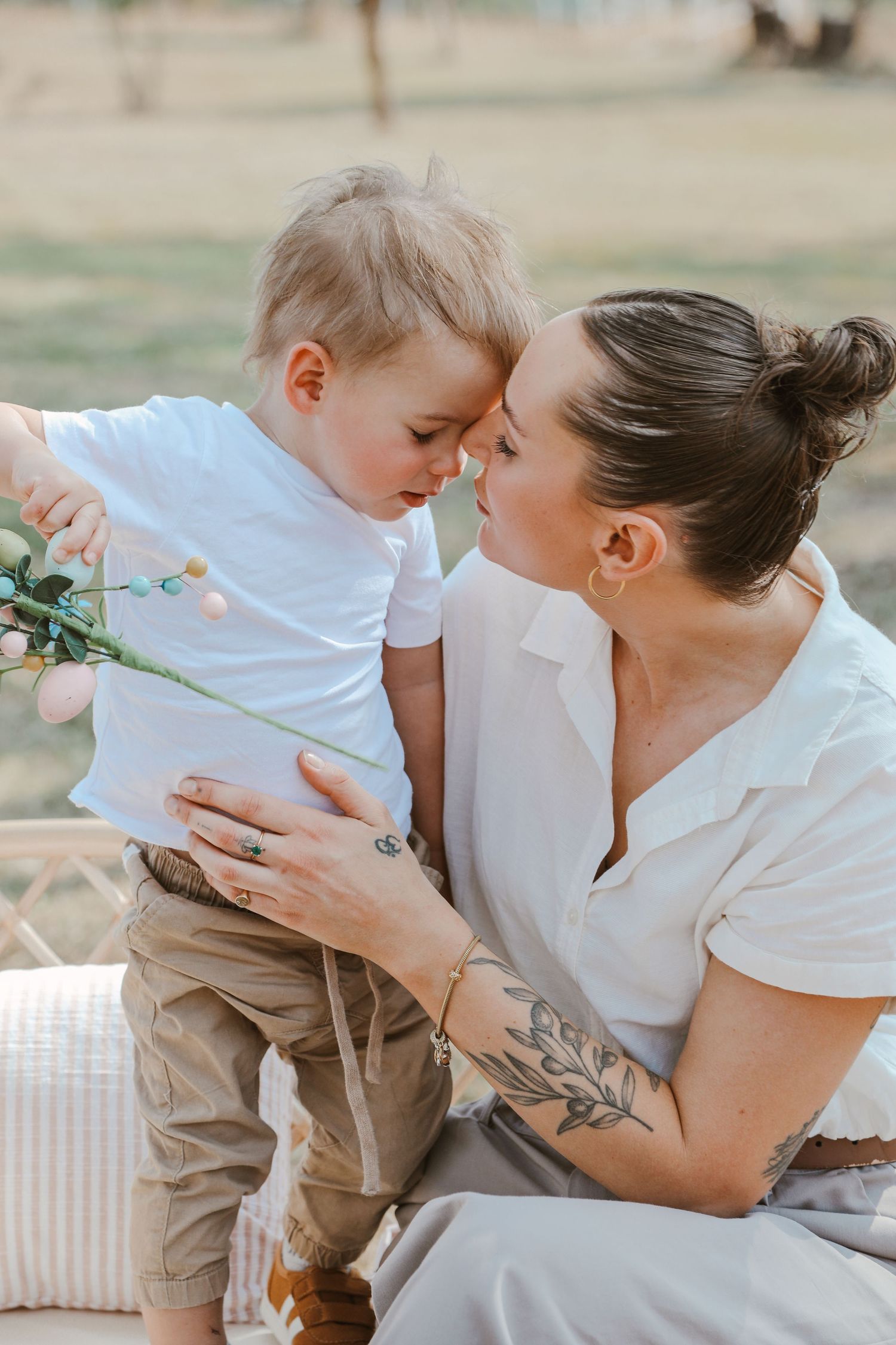 Tender family moment captured in soft natural light with neutral decor.