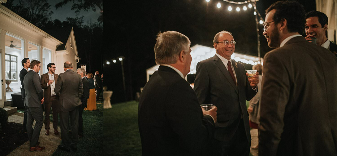 Evening outdoor gathering with guests mingling under string lights near white tents.