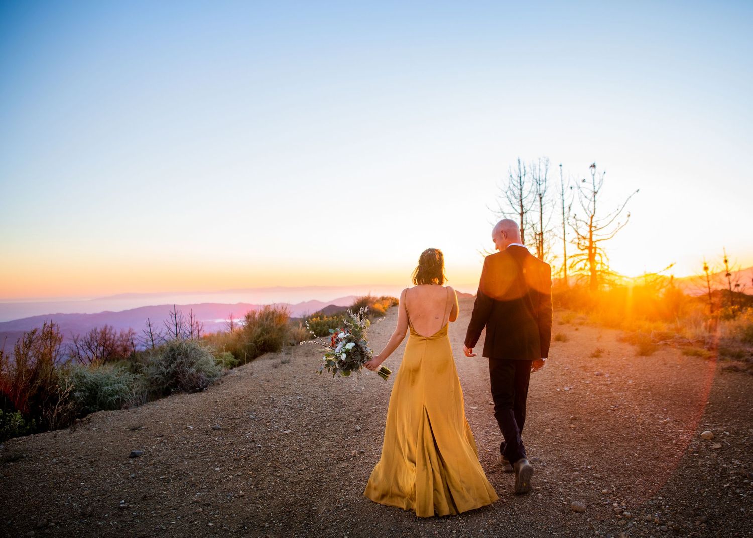 wedding couple walking into the sunset