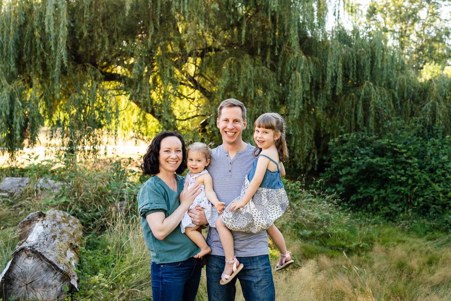 Seattle family photographer captures family portrait in Kirkland under the willow tree.