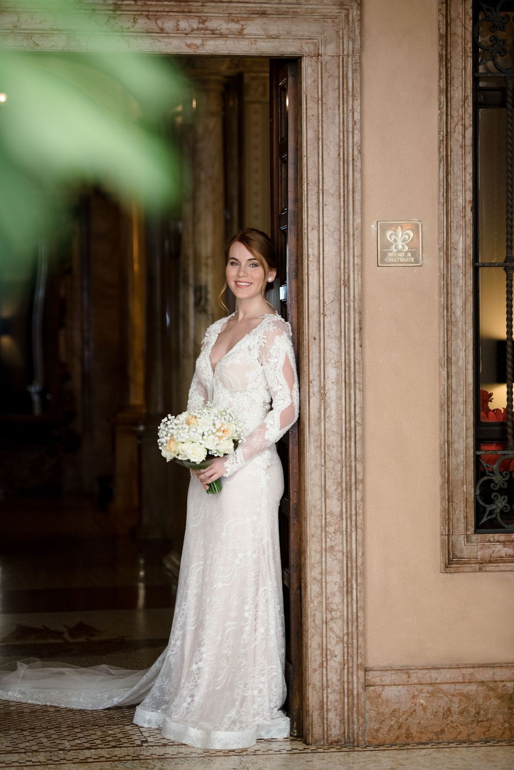 Wedding portraits in an elegant hallway with classic architectural details.