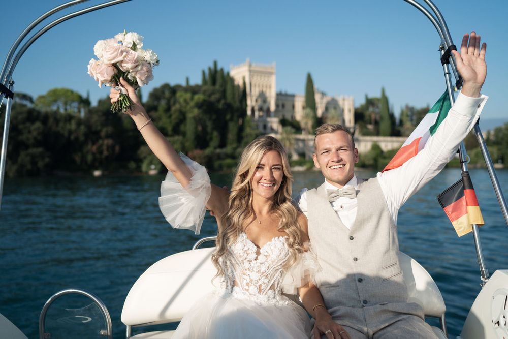 Joyful wedding celebration aboard a boat with scenic water views.