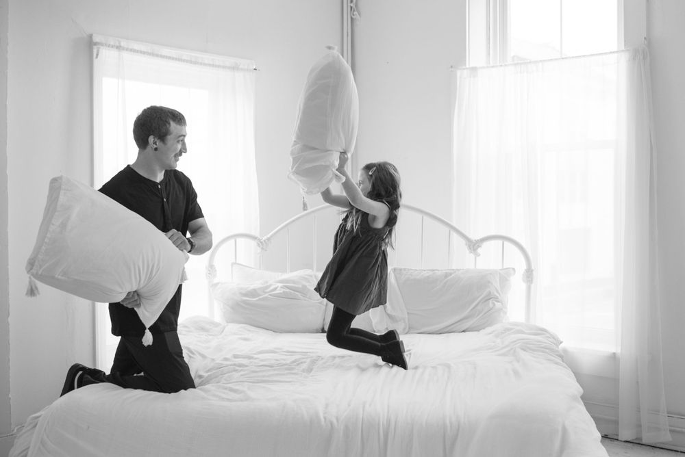 dad and daughter pillow fight in studio