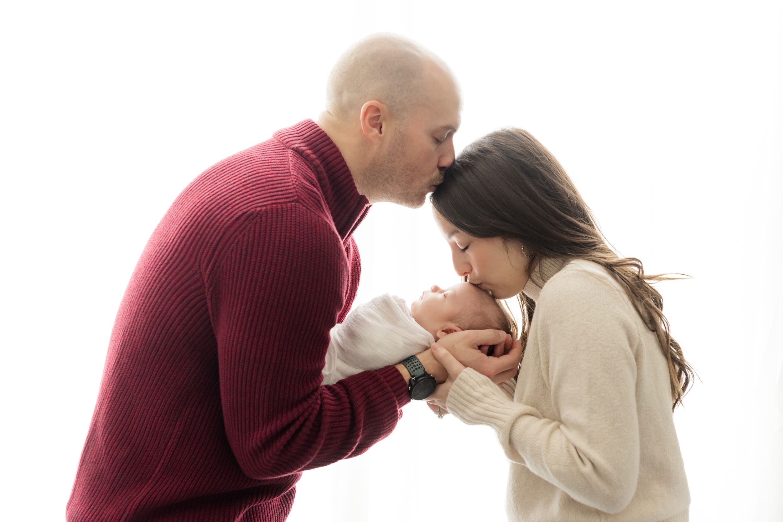 young couple holding newborn baby