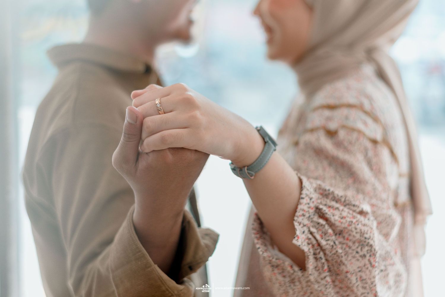 Close-up shot of hands clasped together showing intimacy and connection.