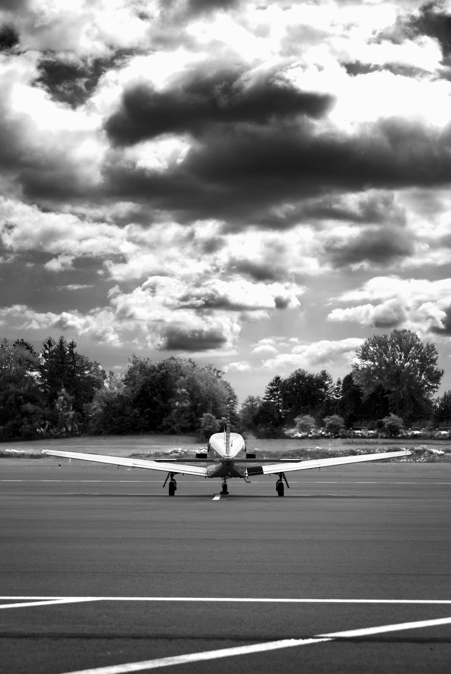 dramatic portrait of piper airplane with clouds in the background.
