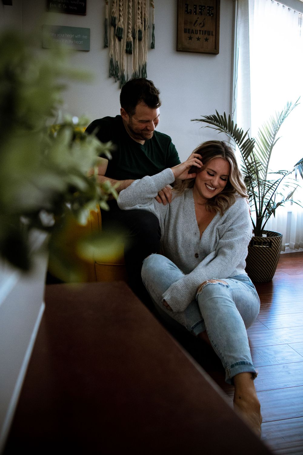 Playful lifestyle photography sequence capturing intimate moments between couple near indoor plants.