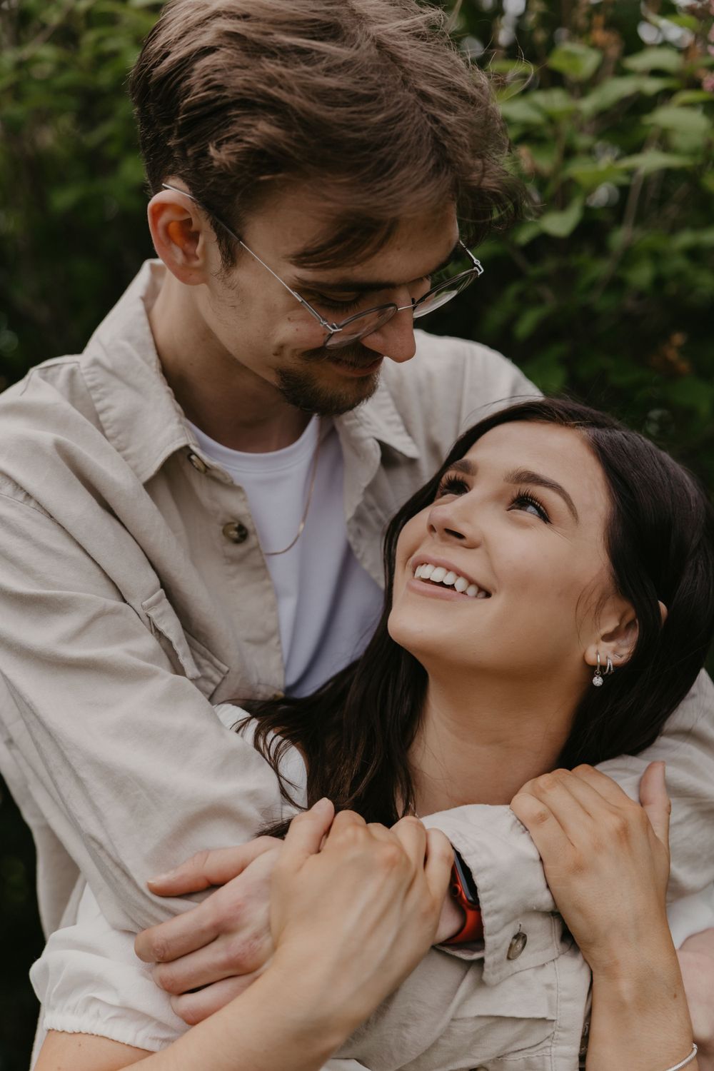 Candid moments of joy and affection captured between a couple in natural lighting.