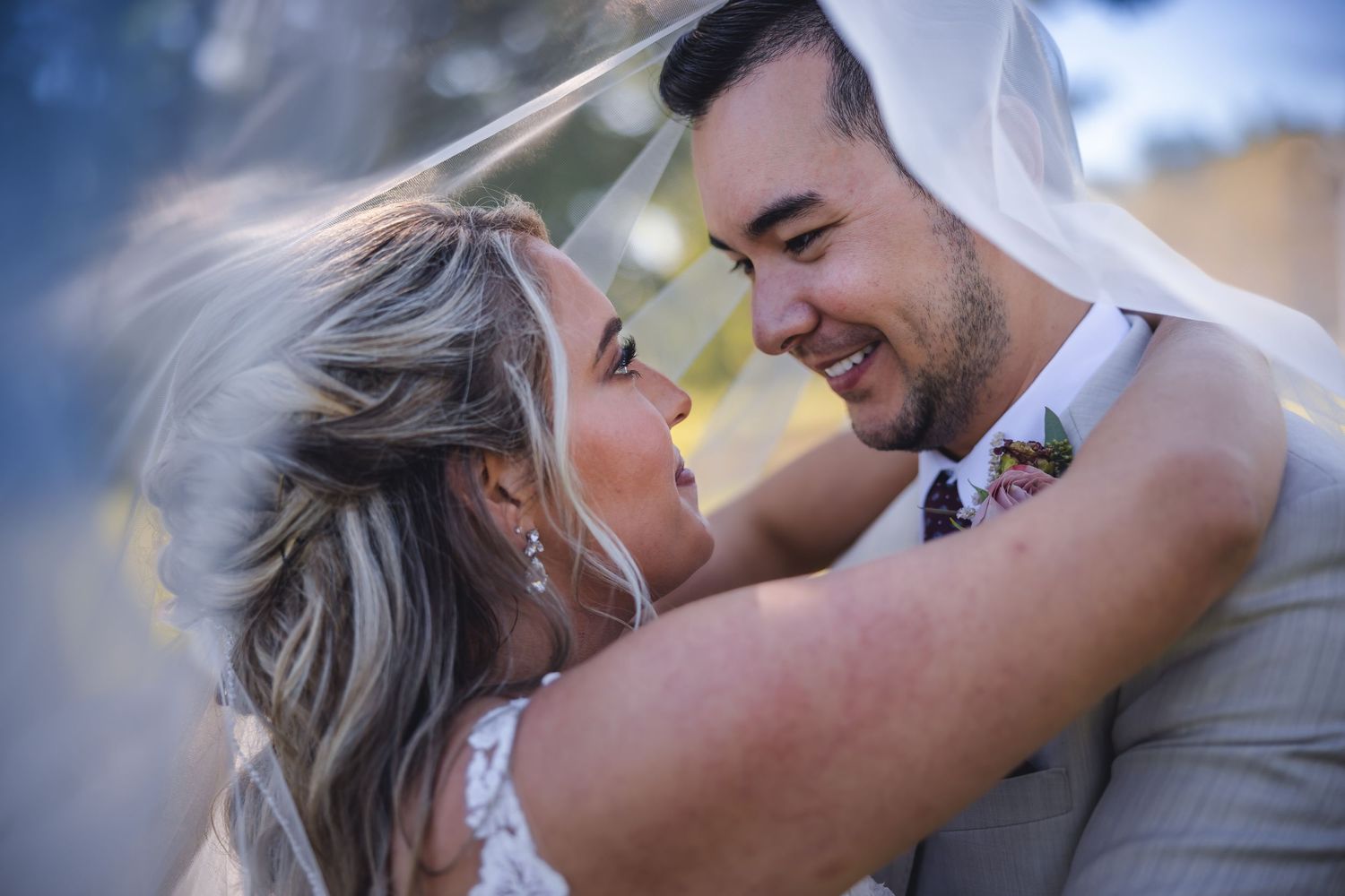 A tender wedding moment captured between a couple during golden hour.