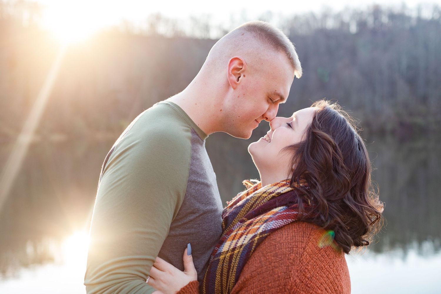 A romantic sunset photoshoot by a peaceful lake with warm golden light.