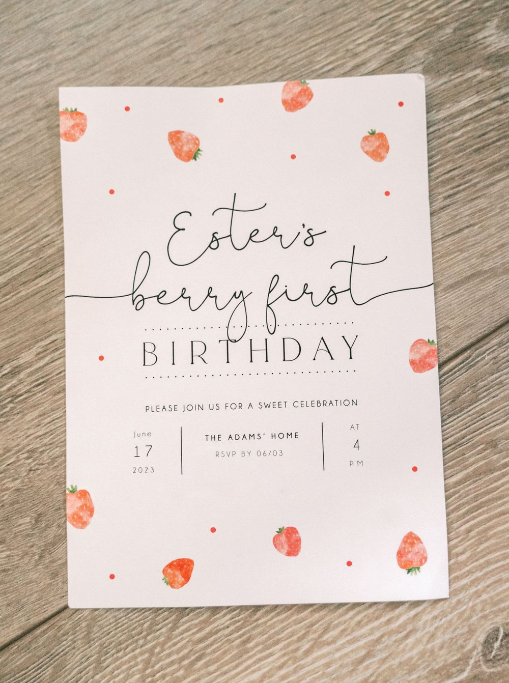 A birthday invitation with delicate watercolor strawberries and elegant script lettering.