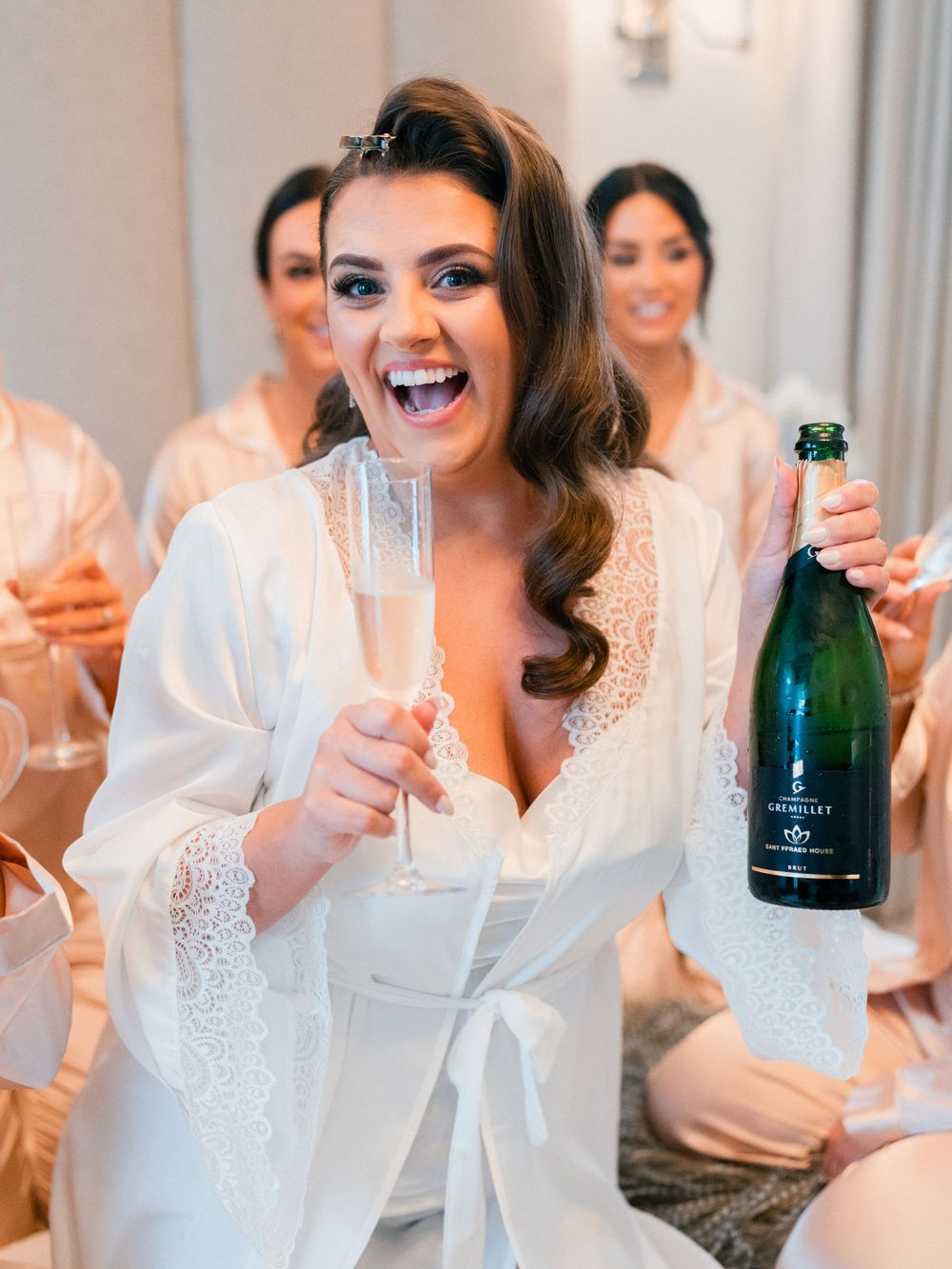 Celebration with champagne and laughter during pre-wedding preparations.