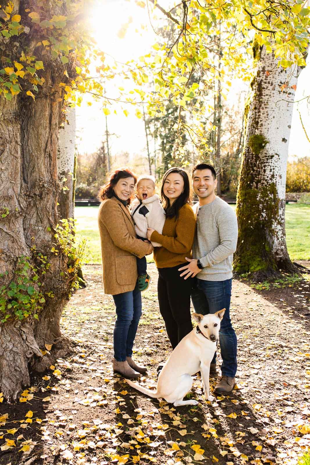 A family hugging each other and their dog in Kelsey Creek Farm