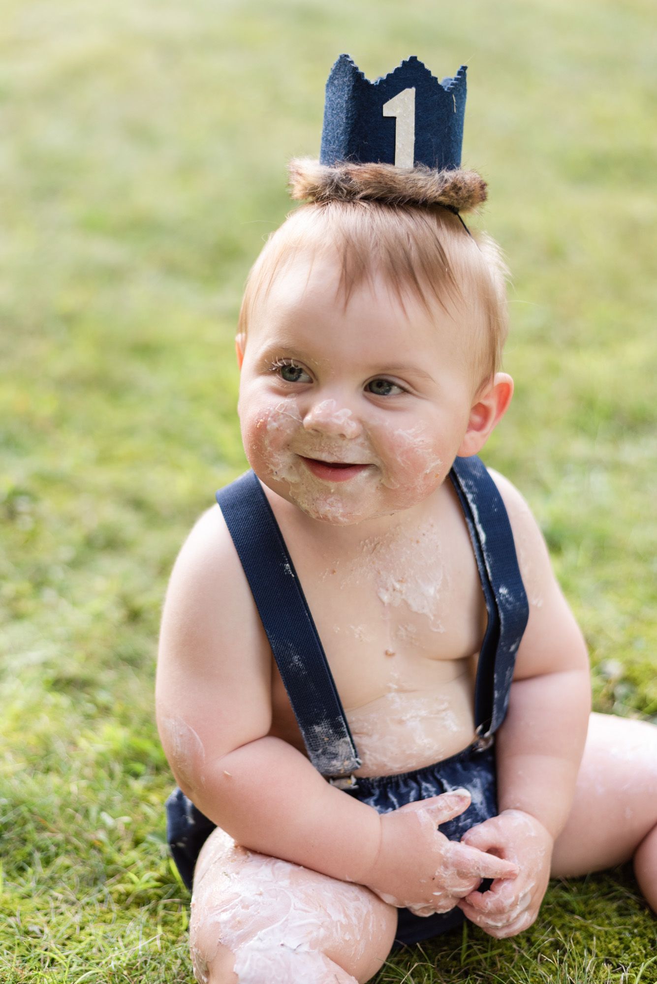 Baby smiling with cake all over his face in Pittsburgh, Pennsylvania