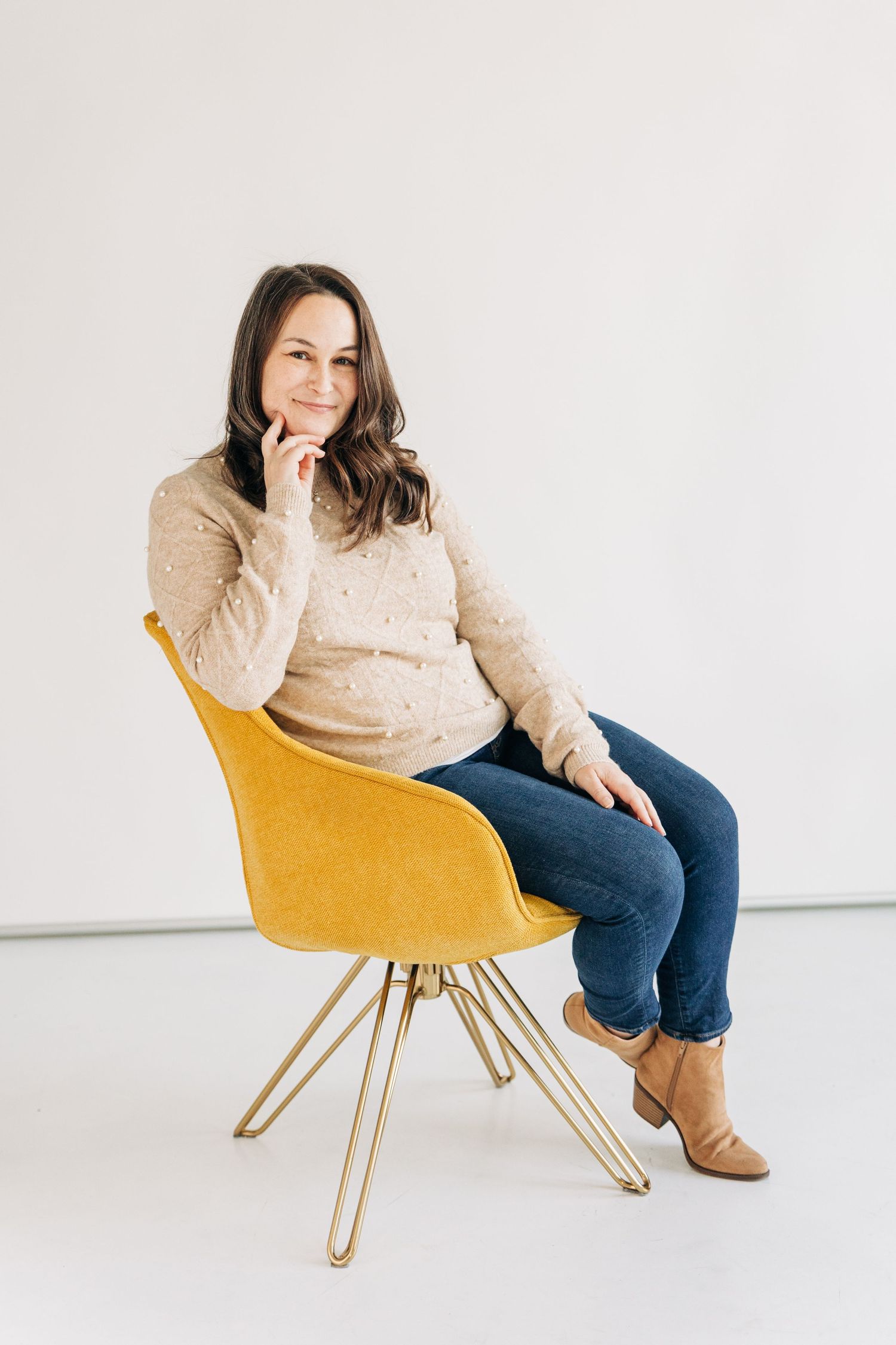 Charlotte branding photography for local artist sitting on yellow chair