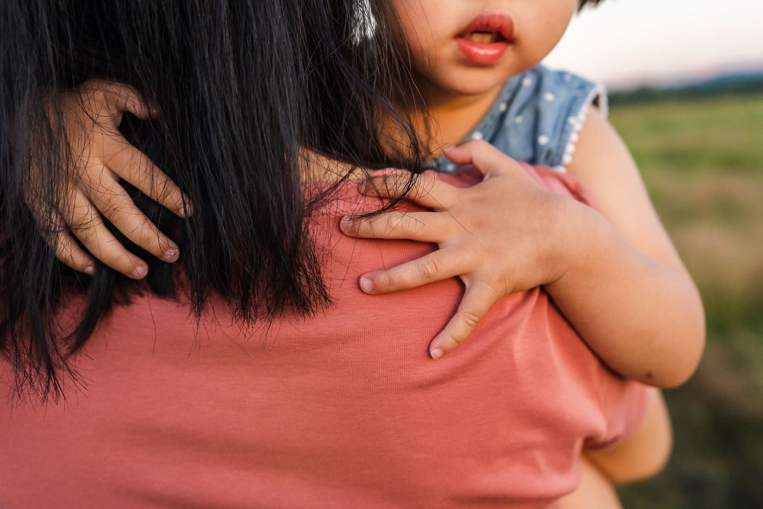 Detail photo of little girls hands at sunset