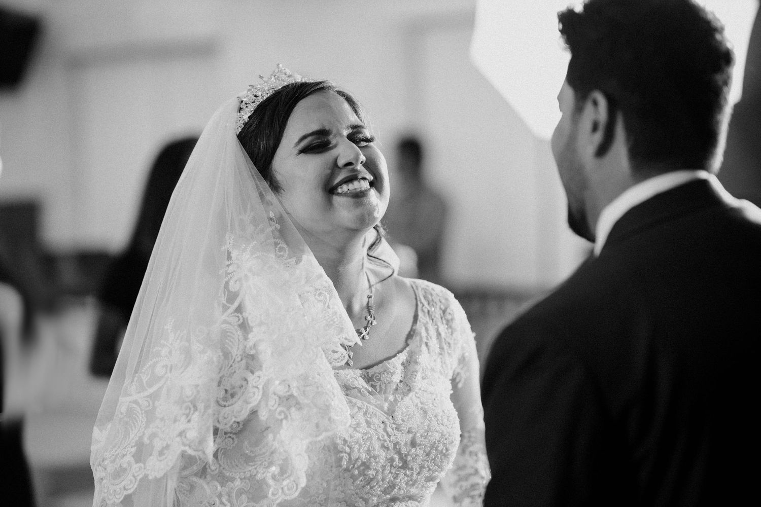 Candid black and white moments captured during an elegant wedding ceremony.