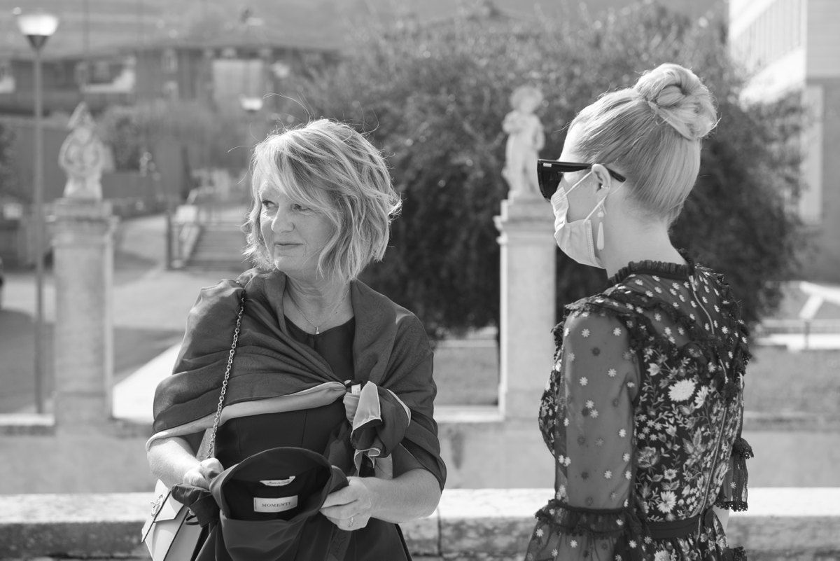Candid black and white photo of event planners discussing details.
