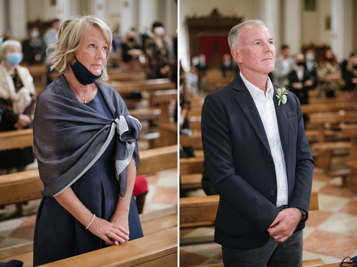 Wedding guests seated in wooden pews inside a traditional Italian church.