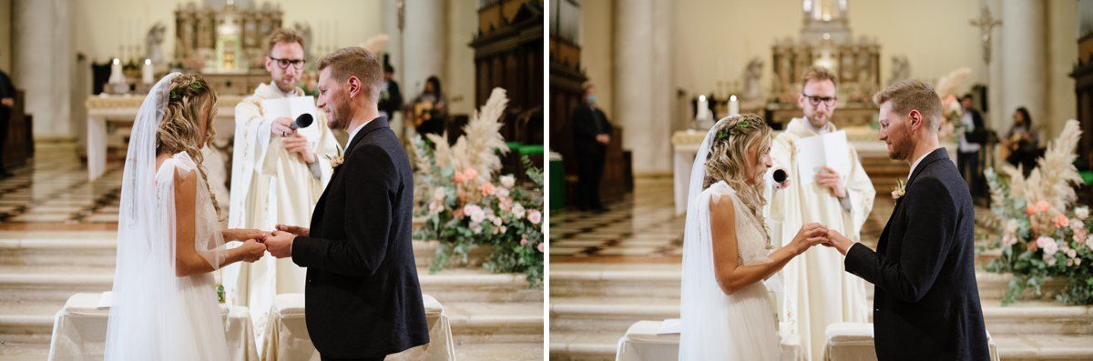 A romantic exchange between newlyweds at the altar of an ornate church.