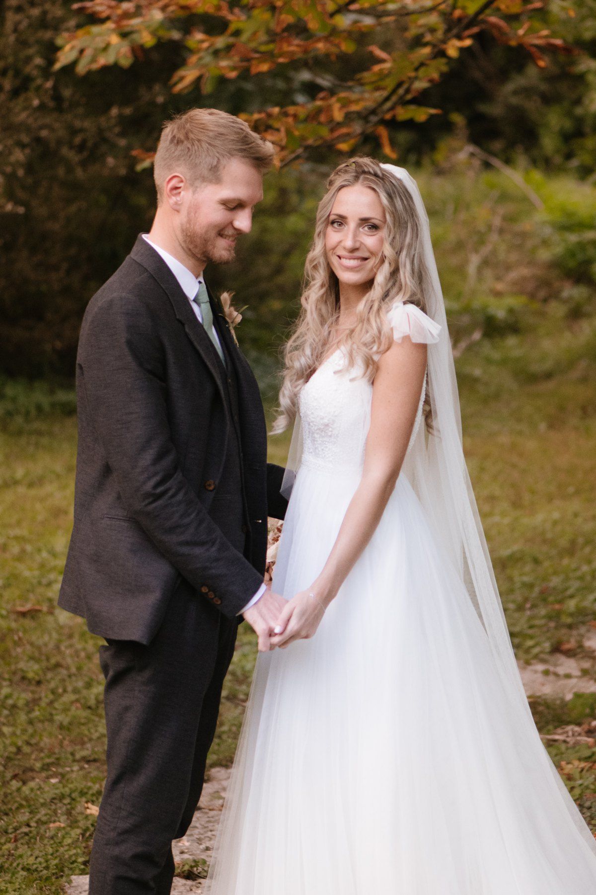 Elegant wedding portrait in autumn garden with beautiful floral details.