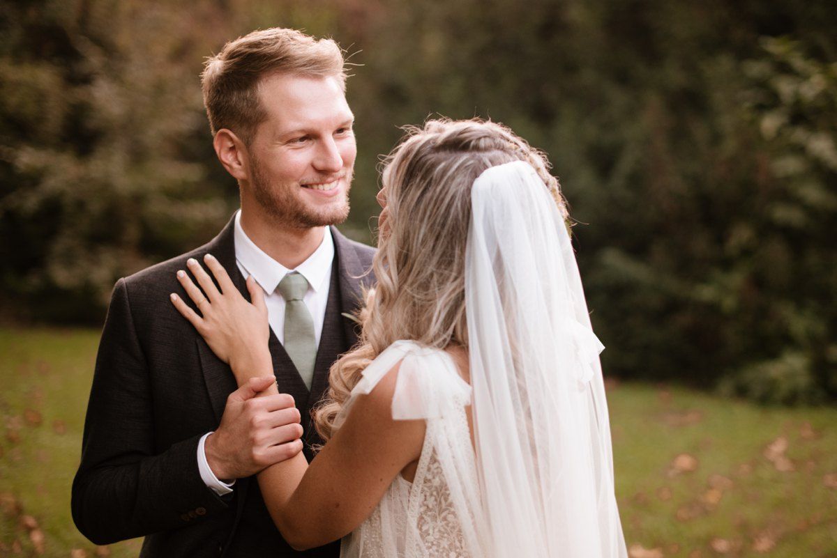 Newlyweds share intimate dance moment during autumn wedding celebration.