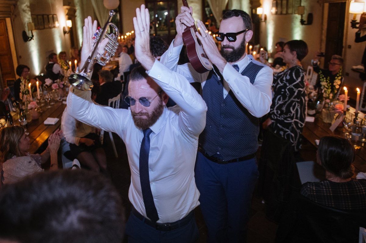 Wedding reception dance party with guests celebrating on dance floor.