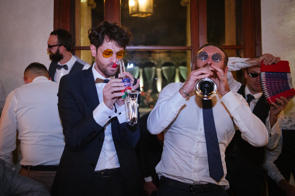 Wedding guests enjoying drinks and celebrations at evening reception.