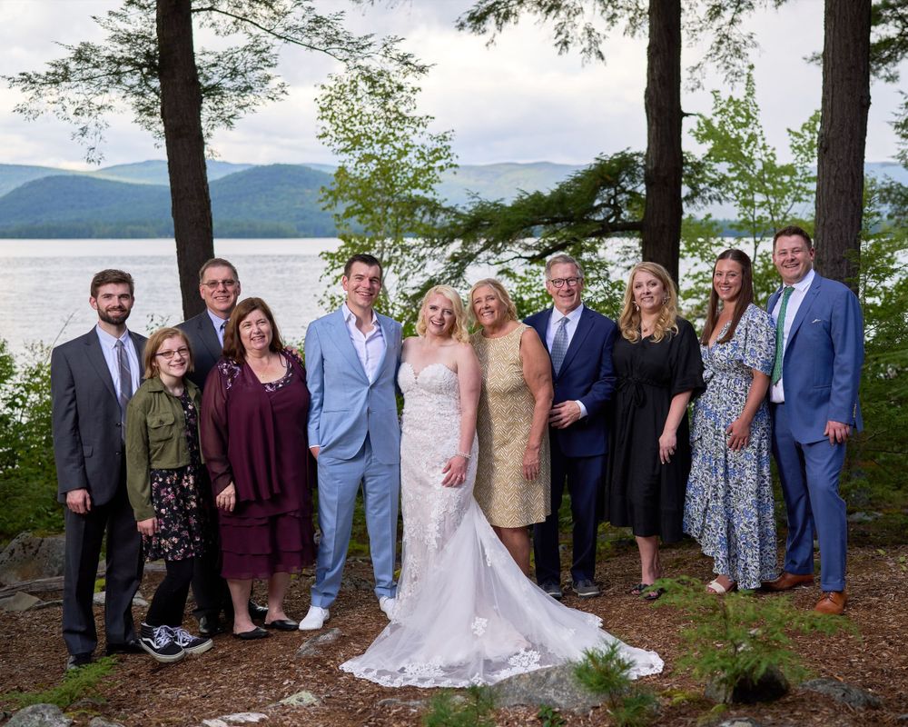 Family members gather with bride and groom for Squam Lake wedding portrait