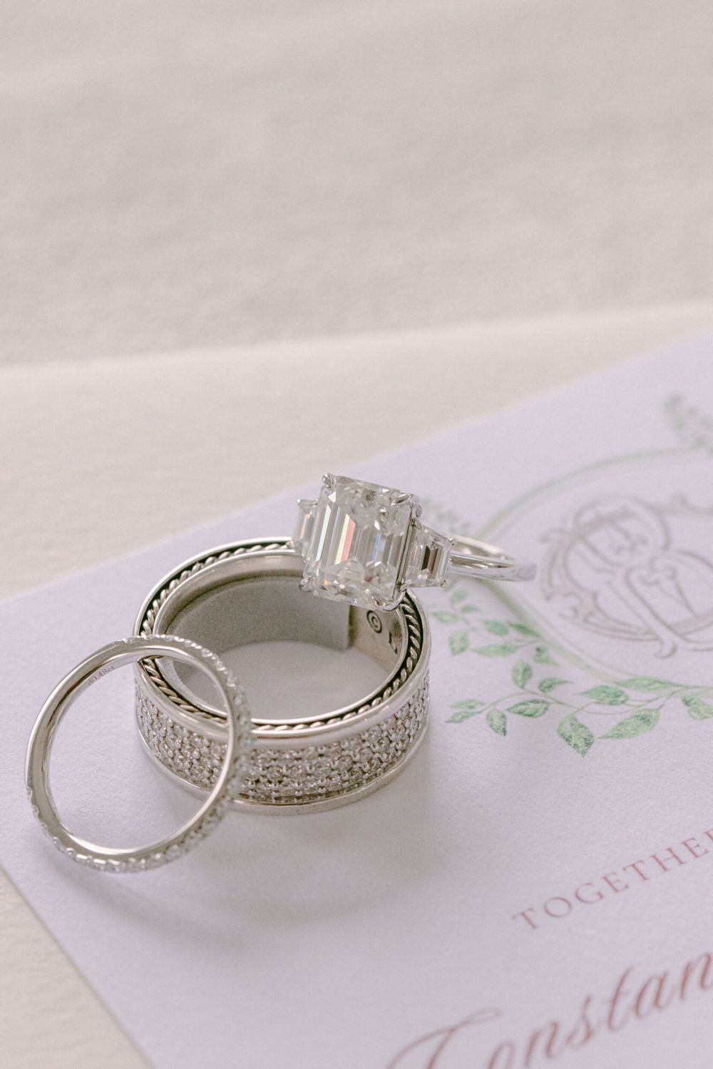Stunning diamond engagement ring and wedding band set photographed on wedding stationery.