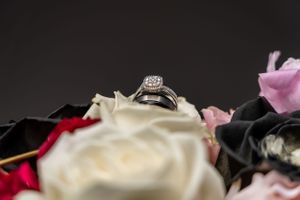 An elegant diamond engagement ring nestled among soft rose petals.