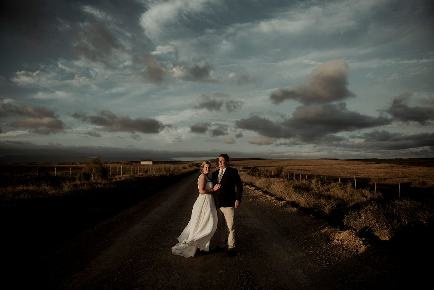 Dramatic Wedding portrait of couple, during golden hour.