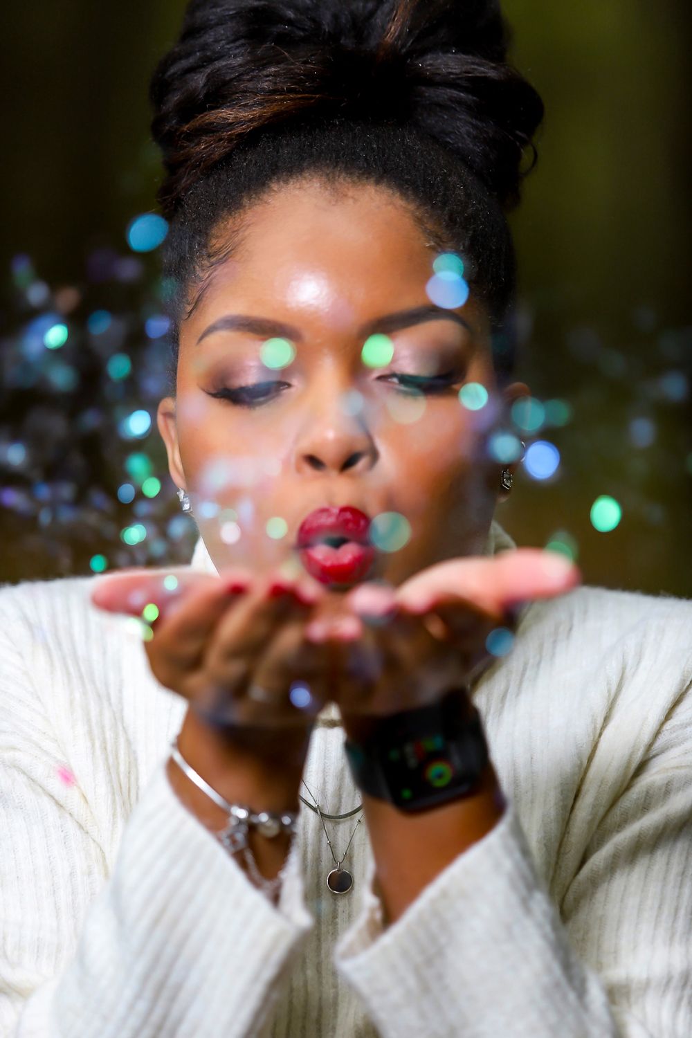 Sparkly photo sequence showing someone blowing glitter in a white sweater with magical lighting effects.