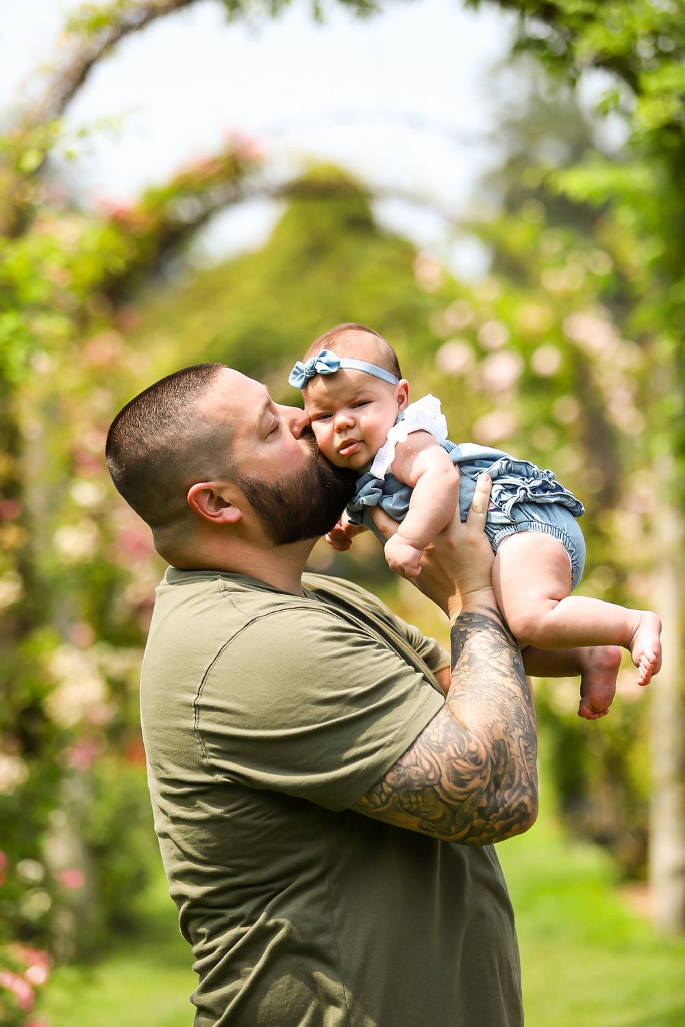 A heartwarming sequence of outdoor photos shows tender moments with an infant in a garden setting.