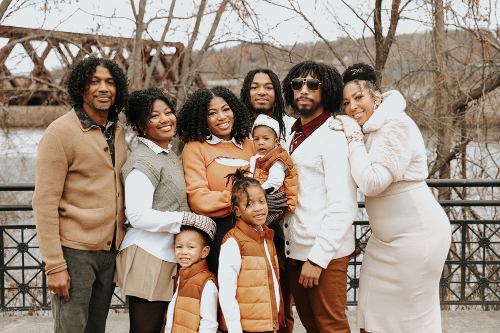 Friends gather for group photos wearing coordinated beige, white and orange outfits in a winter setting.
