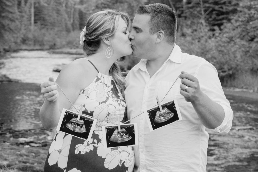Couple expecting triplets hold 3 ultrasound pictures