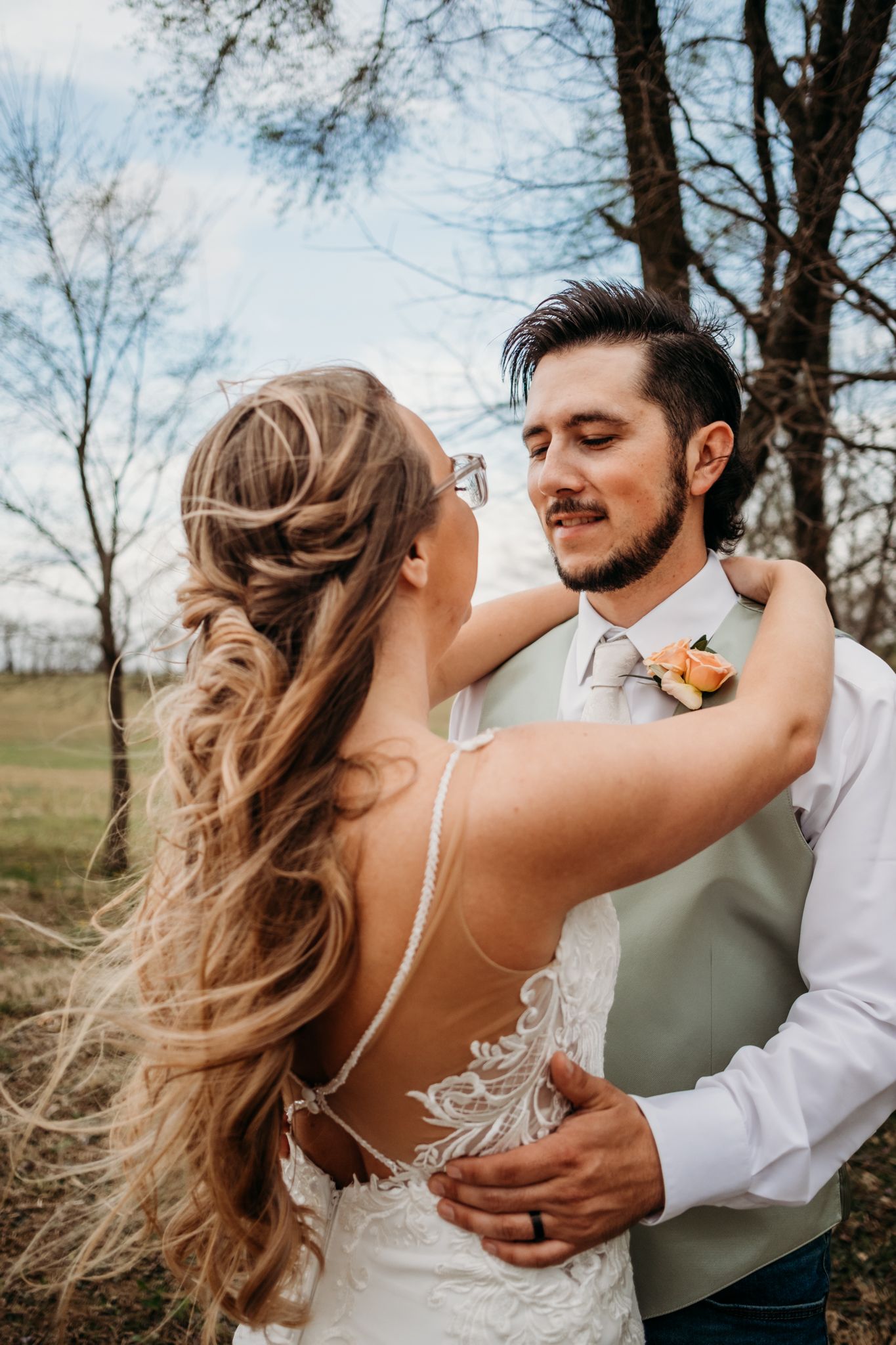 A groom looks at his bride in a wedding portrait by Tiffany Arnold Photography.