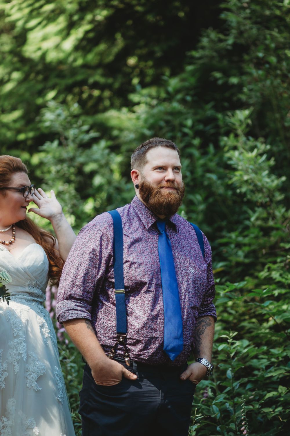 Groom stands waiting to see his bride for the first time in the mountains at his elopement