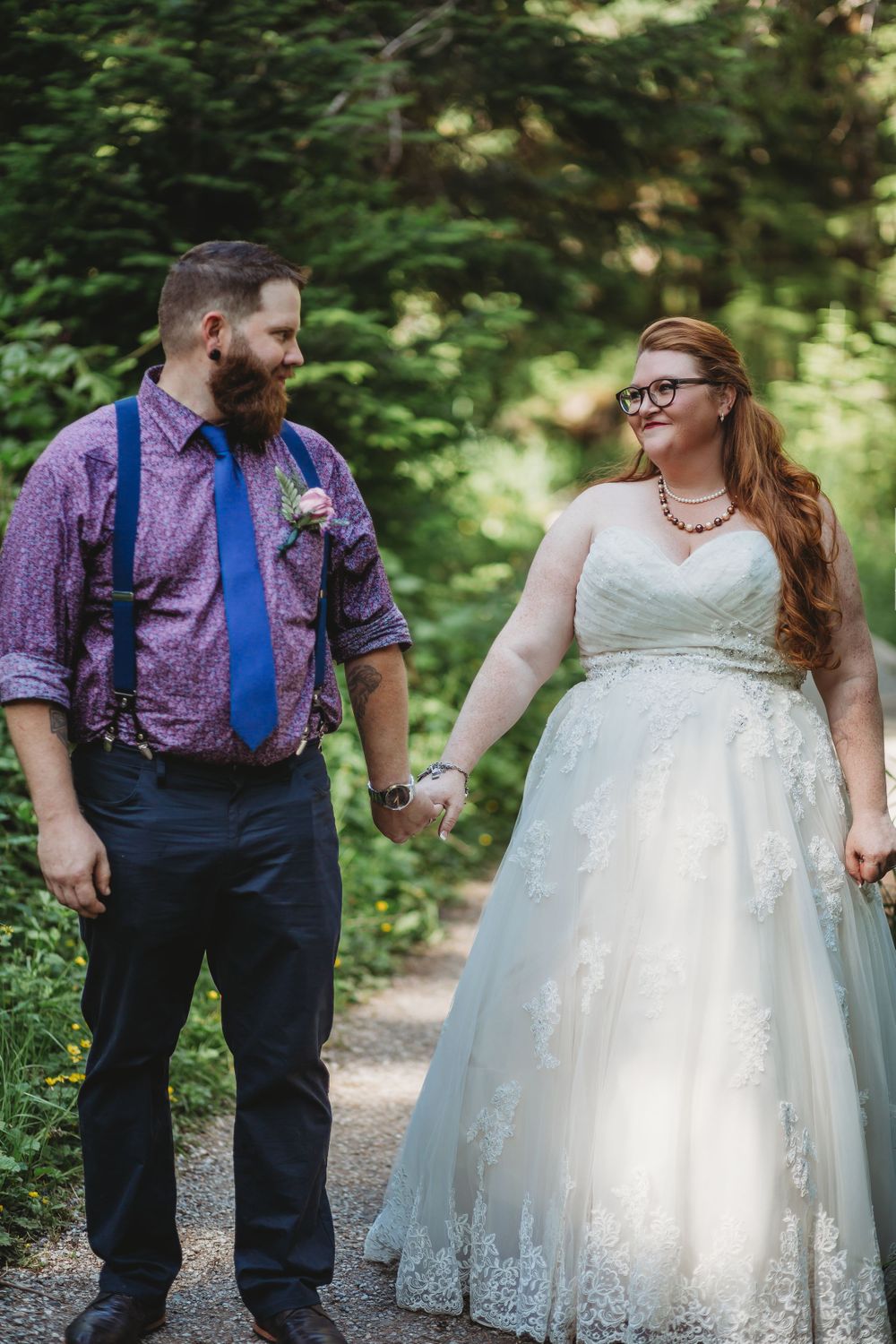 Bride and groom hold hands and smile