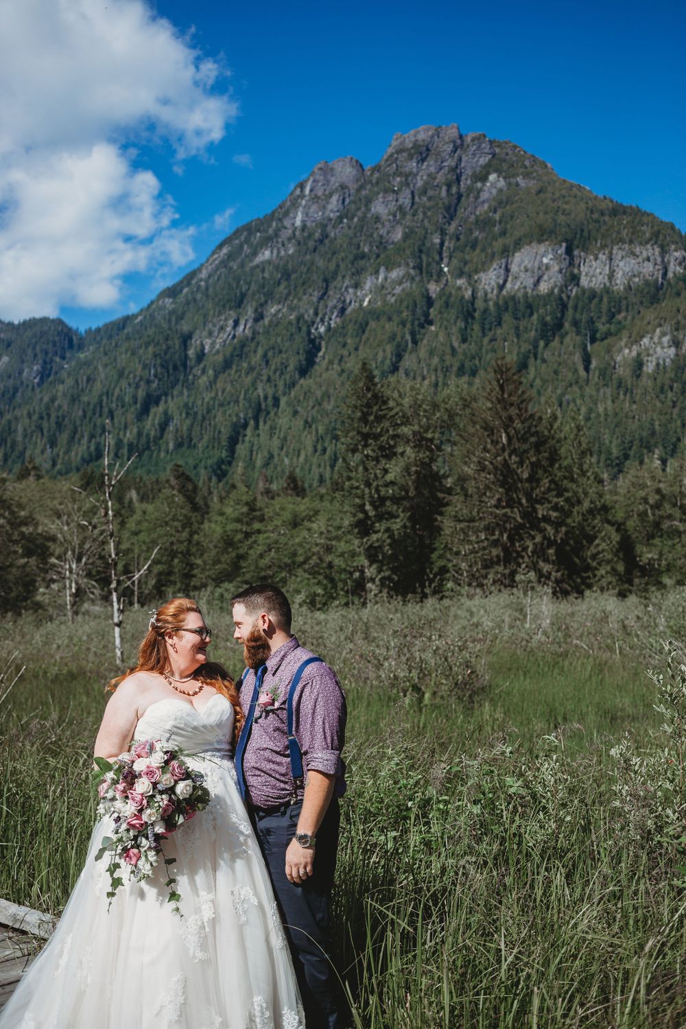 Bride and groom look in eachothers eyes in the mountains at their elopement