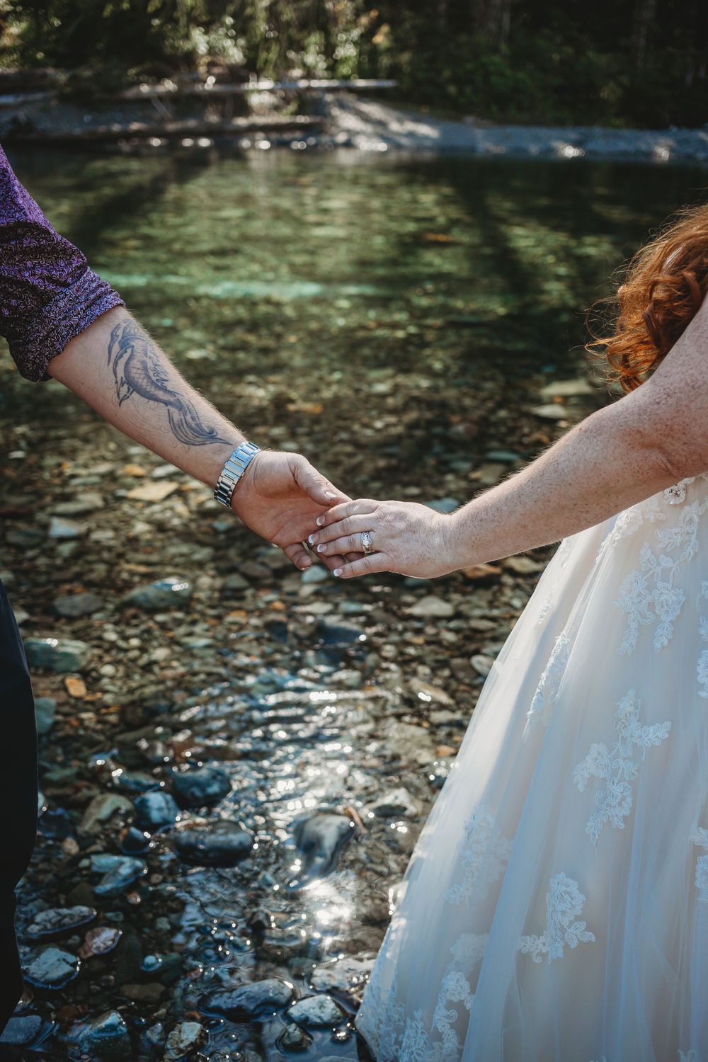 A close up picture of bride and grooms hands