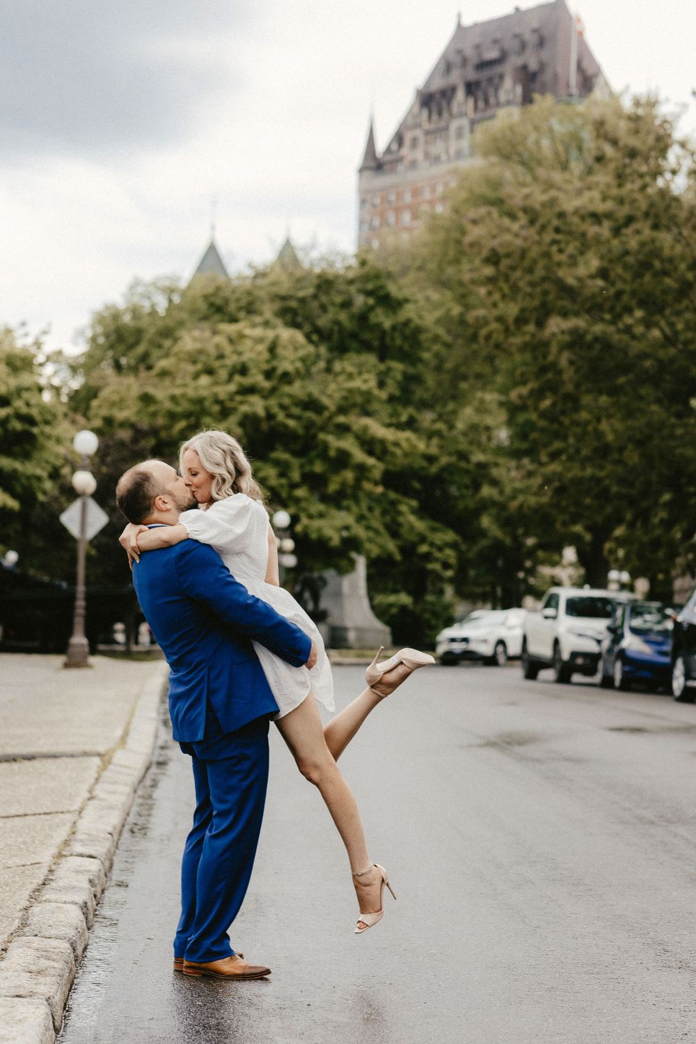 A joyful lift pose captured in front of the majestic Chateau Frontenac.