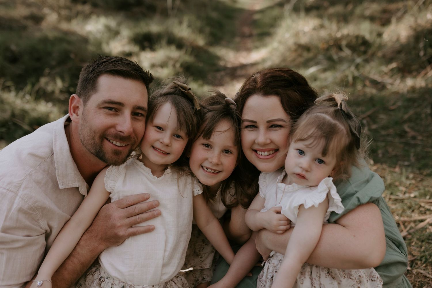 Family enjoying outdoor photo session in warm tones with coordinated casual outfits.