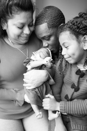 Family surrounding Newborn Daughter
