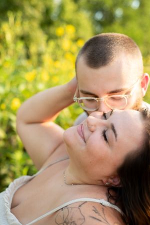 Tanner kissing Torie's Cheek with sunflowers behind